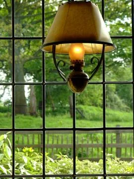 Old lamp by window Stock Photos