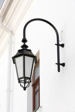 Old lamp with windows on wall. Stock Photos