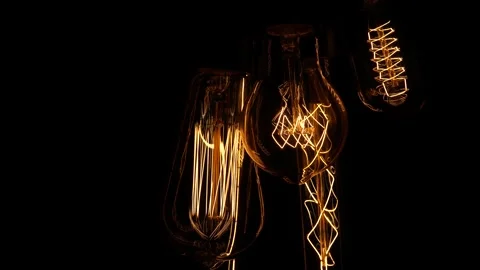 Old lamps on a black background. Several retro lamps turn on and off, pulsing Video stock 244334253