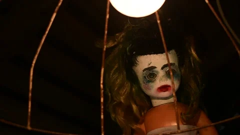 Old lampshade sways in front of the doll Stock Footage 135386641