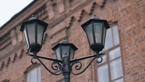 OLD LANTERN IN THE BACKGROUND OF VINTAGE BRICK BUILDINGS Vídeos de archivo 108045964