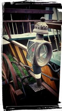 An old lantern on a cart. Stock Photos