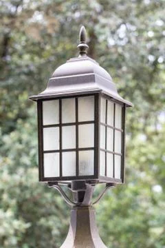 Old lantern on a garden lamp post, retro style and steampunk Stock Photos