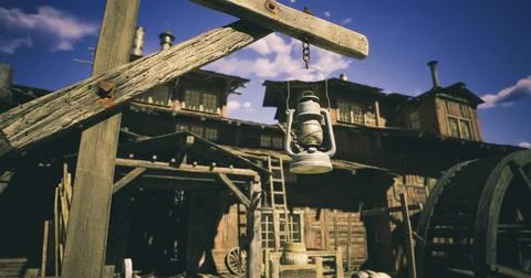 Old lantern hanging in front of rustic wooden buildings under blue sky Ilustración de archivo