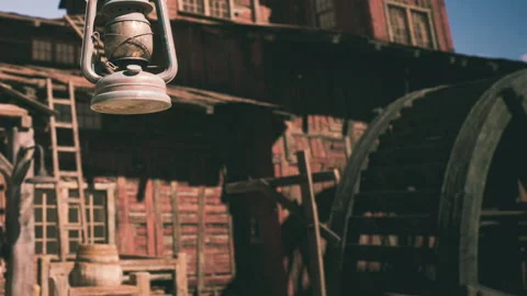 Old lantern hanging in front of wooden barn during sunny day in countryside Stock Footage 344407094
