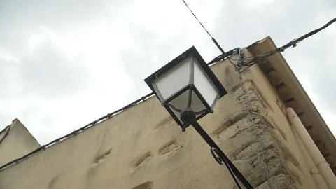 Old lantern on the house on the background of the wires Stock Footage 113225882