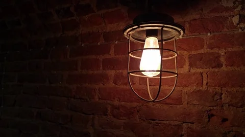 Old lantern illuminates the brick wall around the light, beyound the gloom. Stock Footage 70348506