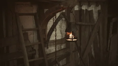 Old lantern illuminating rustic wooden barn interior at dusk Stock Footage 331420696