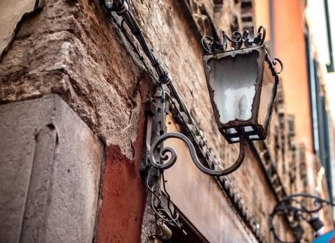 Old lantern on old wall in italy Stock Photos