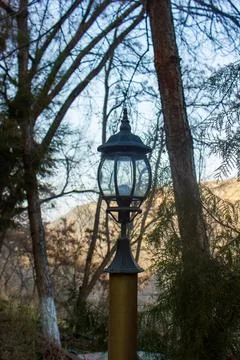 Old lantern in the park on landscape background Stockfoto's