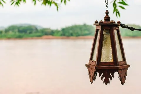 Old lantern with river Stock Photos