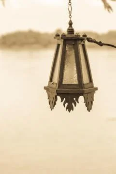 Old lantern with river Stock Photos