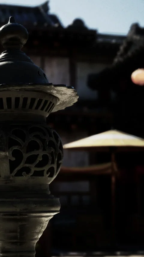 Old lantern stands in a courtyard during a dusk gathering in a traditional town Stock Footage 338390814