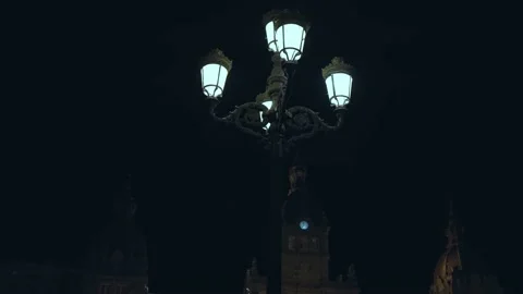 An old large carved black lantern shines on the square at night. Stock Footage 197025762