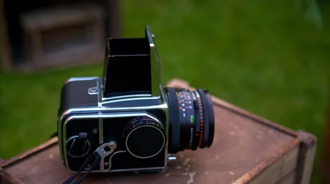 Old large format camera lying on a wooden box on a grass background Stock Footage 65422067