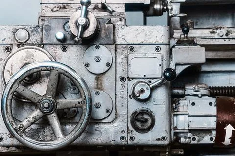 Old lathe for metal processing. Type of metal machine parts in lathe shop at Stock Photos