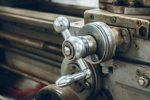 Old lathe for metal processing. Type of metal machine parts in lathe shop at 库存照片