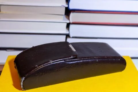 Old leather book on stack of literature isolated background Stock Photos