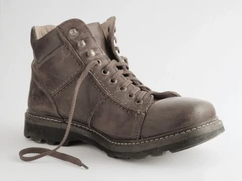 Old leather boot on a white background 스톡 사진