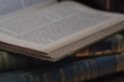 Old leather bound  book open with defocussed words for use as a background Stock Photos