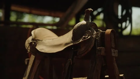 Old leather saddle in rustic ranch environment Stock-Footage 335689224