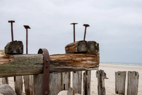 Old leftovers of an old bridge with a rusty rivets on a wooden structure. Stock Photos
