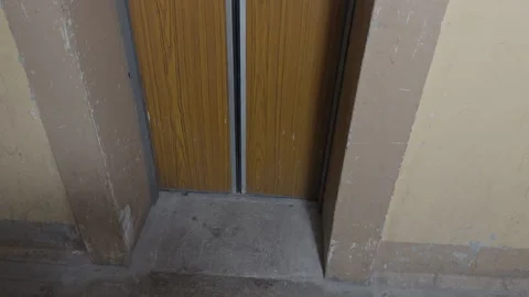 Old lift door with rust. Worn and tarnished elevator frame amid crumbling walls Stock-Footage 335684342