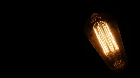 Old Light Bulb Close Up Glowing Filament And Turn Off Stock Footage