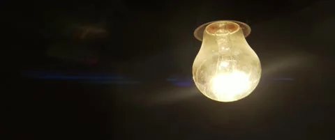 Old light bulb filament glows in the dark 5.7K slomo scope video Stock Footage 304686034