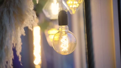 An old light bulb is hanging on a wire Stock Footage 242806843