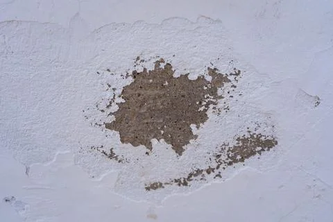 Old light wallpaper wall background, white peeling plaster, textured putty. Dark Stock Photos