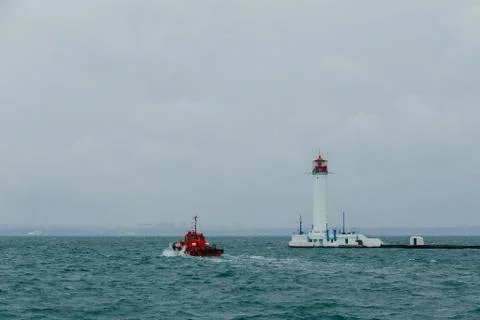 Old lighthouse against the background of clouds and the sea in the seaport of Od Stock Photos