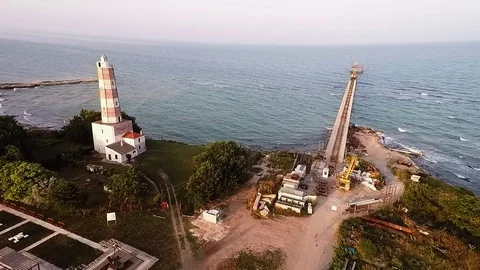 Old lighthouse and a building bridge on the Black Sea coast. Stock Footage 80903632