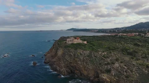 Old lighthouse on a cliff at sunset Stock Footage 230985059