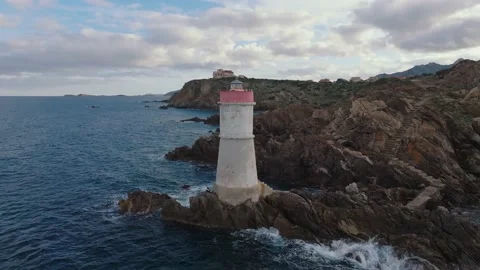 Old lighthouse on a cliff at sunset Stock Footage 230994944