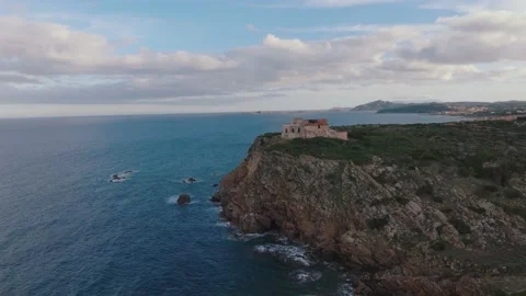 Old lighthouse on a cliff at sunset Stock Footage 230995544