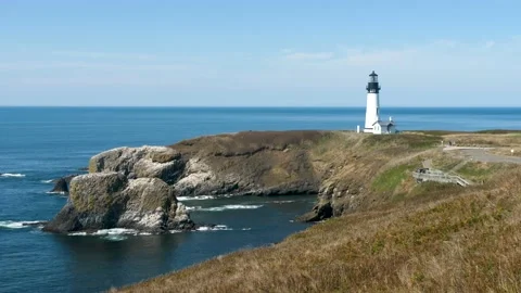 Old lighthouse on the Oregon Coast during a beautiful sunny day Stock Footage 147693529