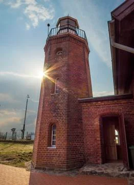Old lighthouse of red brick at sunset in Klaipeda, Lithuania Stock Photos