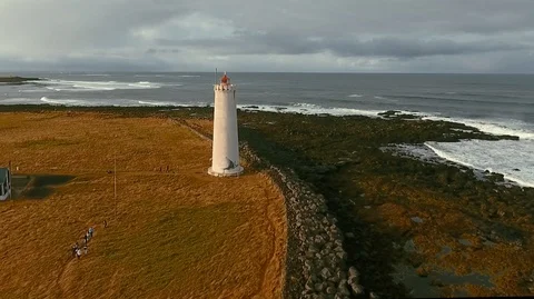 Old lighthouse with reflection in ice and moving clouds timelapse video - Stock Footage 119996550