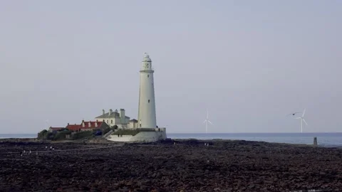 Old Lighthouse On The Seashore With Distant Wind Turbines In The Evening Stock Footage 281961022