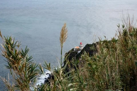 Old lighthouse on the shore Stock Photos