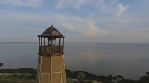 Old lighthouse at sunset. The ancient lighthouse Stockbeeldmateriaal 90342035