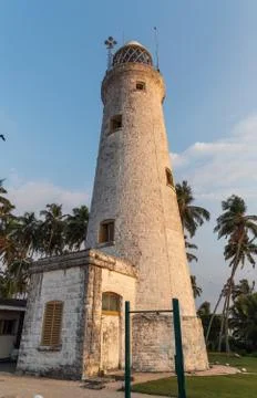 The old lighthouse of white stone located on the island 스톡 사진