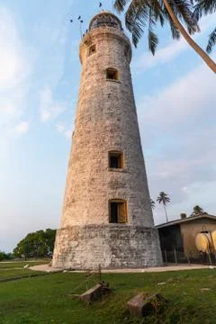 The old lighthouse of white stone located on the island 스톡 사진