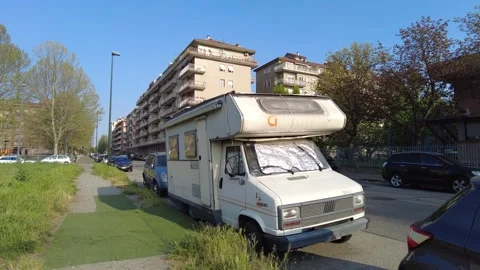 Old lived-in camper van used as a makeshift home in a suburban area Stock Footage 332513528
