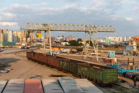 An old loading station with rusty wagons, containers and a steel construction Stock Photos