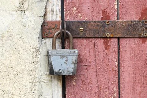 Old lock on the door.Rusty lock on the door of an old farmhouse . True villag Stock Photos
