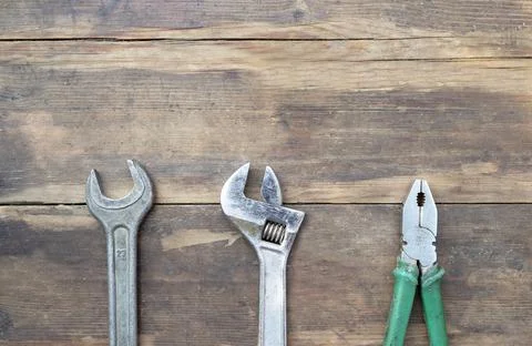 Old locksmith tools on dark brown wooden background Stock Photos