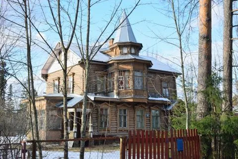 Old log chopped, two-storey house with a turret Stock Photos