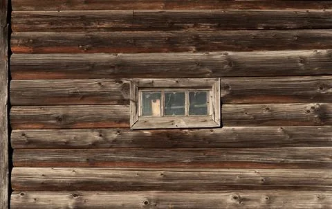 Old log wall with small window Stock Photos